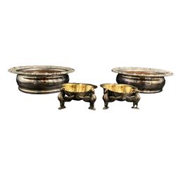 Pair of Victorian silver-plated trifom salts, gilt interior with scalloped rim, raised on Phoenix suppors, W7cm together with a pair of silver-plated bottle coasters with turned base and acanthus moulded borders (4)