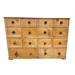 Victorian pine multi drawer chest, with twelve small drawers over two long, raised on bun feet W115cm, H80cm, D46cm