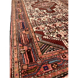Iranian  red ground runner, triple medallion on pale field decorated with repeating motifs 
