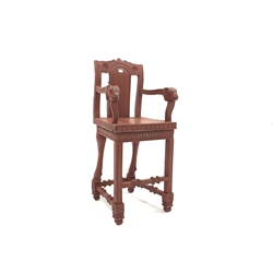  20th century Indo-Persian design carved and painted hardwood high chair, ram head arm terminals, panel seat, floral caved frieze, raised on square moulded front supports and turned rear supports in the form of rams legs, W50cm, H105cm, D50cm  