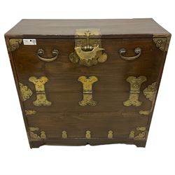 19th century Korean brass bound elm morijang or cabinet, fall-front cupboard enclosing three small drawers and large compartment, the brass fittings pierced with geometric patterns, with heavy brass lock in the form of a fish