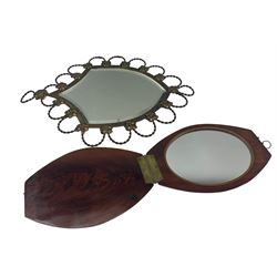 Art Nouveau shield shaped wall mirror with scrolled and floral edging together with hinged travel mirror 
