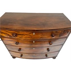 Late Regency figured mahogany bow-front chest, fitted with four graduating drawers, on turned and lobe carved feet, with bone lozenge escutcheons 