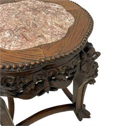 Late 19th to early 20th century carved hardwood jardinière or urn stand, shaped rose marble top enclosed by bead carved surround, the frieze rails carved and pierced with foliage decoration, on dragon mask carved cabriole supports with ball and claw feet united by curved stretchers
