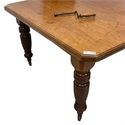 Late Victorian mahogany dining table, rectangular canted and moulded top, telescopic extending action with two additional leaves, on turned and reed moulded supports, brass and ceramic castors 