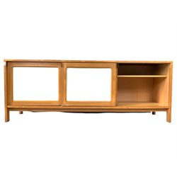 Mid century modern beech and white laminate sideboard, three sliding panelled doors enclosing fixed shelves and four drawers, raised on stile supports 200cm x 49cm, H75cm