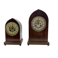 Two French 19th century lancet cased mahgogany 8-day mantle clocks, one with a two-part enamel dial and a visible Brocot escapement, Roman numerals, minute markers and steel moon hands, striking the hours and half hours on a bell.  With pendulum.
W22cm D13cm H36cm 
A second with a recessed enamel dial with brass filigree decoration to the centre, Arabic numerals, minute markers and steel spade hands, striking the hours and half hours on a coiled gong. 
With Pendulum. 
W18cm D13cm H28cm 
