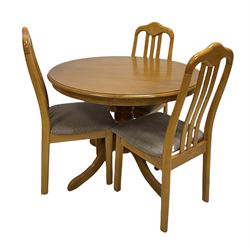 Traditional style beech dining table, circular top raised on turned column and four reeded splayed supports (D101cm) together with a set of three dining chairs (W45cm)
