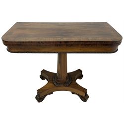 William IV rosewood card table, rectangular swivel and fold-over top with lined interior, the frieze with applied beaded edge, square chamfered and tapered column on shaped platform with gadroon and acanthus leaf carved frame, raised on scroll carved feet