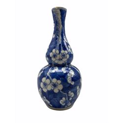 19th/ early 20th century Chinese gourd shape vase decorated with prunus in blue and white with four character mark to base, H21cm 