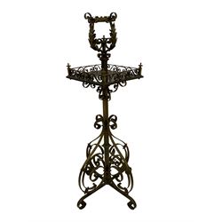 Late 19th century Aesthetic Movement ornate brass standard lamp, the top with scrolling acanthus leaves, the central rosewood table with pierced scroll gallery, raised on a turned column with x-base on scroll feet