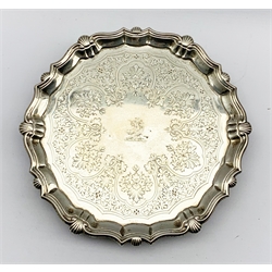 George II small silver circular salver engraved with a crest and later engraved decoration within a shell moulded border and on stepped supports D22cm London 1747 Maker John Robinson 12.8oz