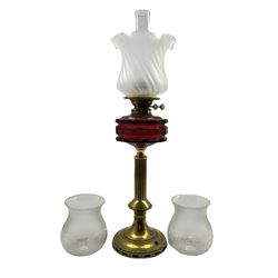 Victorian brass oil lamp with faceted ruby glass reservoir, reeded brass column and wrythen frosted glass shade, H71cm (including funnel) together with a pair of etched glass shades (3)