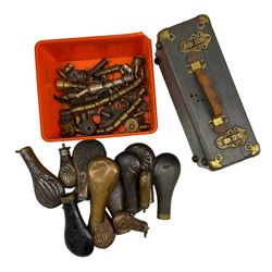 Thirteen copper and brass powder flasks, various brass nozzels, together with a WWII Gun Sight Aiming box 