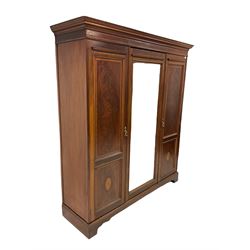 Edwardian mahogany wardrobe, the projecting cornice with chequered inlay, over one central glazed door, flanked by two doors with fan inlays, opening with interior fitted for hanging and with two drawers,  raised on bracket supports