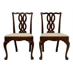 Set four George III mahogany dining chairs, shaped cresting rail over interlaced splats, the drop in seats upholstered in later patterned ivory fabric, moulded seat rails with shaped apron, raised on cabriole front supports terminating to pad feet