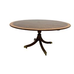 Georgian design mahogany tilt-top centre table, circular top with satinwood crossbanding and ebony and boxwood stringing, ring turned vasiform pedestal with splayed supports terminating in brass hairy paw feet and castors