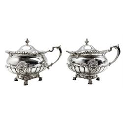 Early 20th century silver double condiment set of circular design with gadrooned borders, lion mask ring handles and masks of the Tyne God and on claw feet comprising pair of salts , pair of pepperettes and pair of mustard pots London 1915 Makers Mark B & S and with makers mark of Reid & Sons, Newcastle on Tyne 40oz 