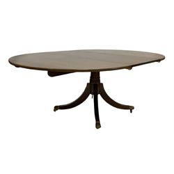 Gotts of Pickering - Late 20th century Regency design mahogany dining table, the oval top with one additional leaf raised on a turned column and four splayed supports terminating in brass hairy paw castors, by Gotts of Pickering 197cm x 137cm, H73cm