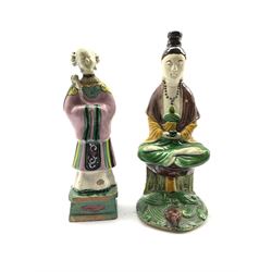 Chinese Sancai glazed figure depicting Guanyin H24.5cm together with a Chinese Famille-Rose figure of an immortal wearing a pink robe (2)