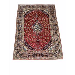 Persian Kashan red ground rug, the lobed medallion on busy red field, enclosed by border 273cm x 395cm