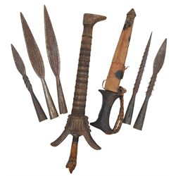 Indonesian Kris with waved steel blade with carved animal head grip and wooden scabbard, dagger in leather sheath and five fishing spear heads (7) 