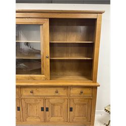 Large French oak dresser, the top section enclosed by two sliding glazed doors, the base fitted with three drawers and cupboards