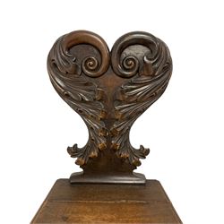 19th century oak hall chair, shaped foliate wing back with scrolling, raised on turned and lappet carved supports