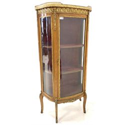 20th century French bow front vitrine, pierced brass gallery over and marble top single glazed door enclosing two shelves, gilt metal mounts, raised on shaped supports with sabot feet W57cm, H140cm, D33cm