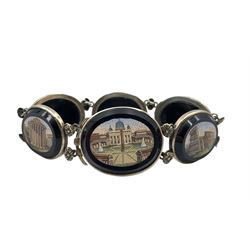 19th century Grand Tour micro mosaic bracelet composed of six oval panels depicting Roman Architecture, including The Colosseum, Parthenon, Temple of Hercules and other buildings, each set within an oval onyx and white metal surrounds, each mount interspersed with two embossed white metal flowerheads attached to a double row chain and push clasp, L19.5cm, largest panel 3cm x 2.5cm