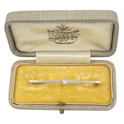 Early 20th century platinum and 15ct gold milgrain set single stone diamond brooch, stamped, in silk and velvet lined box