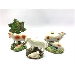 Two early 19th century Staffordshire Pearlware figures, the first modelled as a sheep and lamb before bocage, the sheep initialled P.R, the second modelled as a Sheep with lamb feeding and a further 19th century Staffordshire sheep group (3)