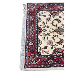 Persian Kashan ivory ground runner rug, the field decorated palmettes interlaced with scrolling foliate branches with flower heads, the crimson border with repeating floral patterns guarded with indigo bands
