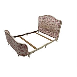 French style cream finish 4' 6'' double bedstead, the moulded frame with floral carved cresting rail, upholstered in cream ground fabric with crimson interlacing foliate pattern, with bed base and mattress