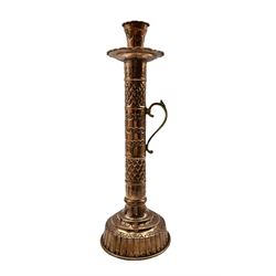 Copper and brass handled candle holder of cylindrical form with engraved decoration on reeded circular base, H48cm 