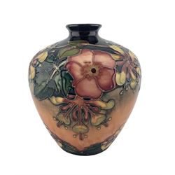 Moorcroft pottery vase decorated in the Oberon pattern on blue ground, date cipher 1994 H18cm