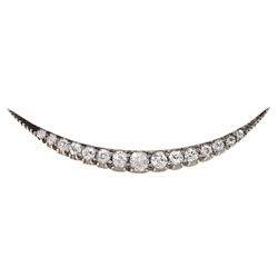 Early 20th century gold and silver graduating old cut diamond crescent brooch, total diamond weight approx 0.60 carat