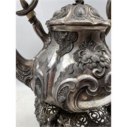 Large Victorian Britannia metal tea kettle with raised patterns of flowers and scrolls, opaque glass handle and on a pierced spirit heater stand H45cm