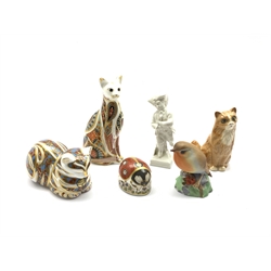 Berlin white glazed porcelain figure ice skating on square base H11cm, three Crown Derby paperweights with silver stoppers, Royal Doulton cat and a Royal Worcester Robin
