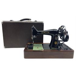 A cased Singer sewing machine, the case is faux crocodile skin
