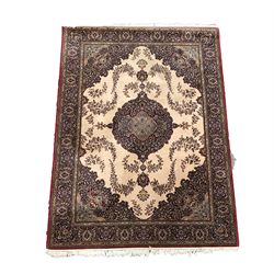 Persian design ground rug with floral medallion on beige field, enclosed by guarded border 255cm x 179cm
