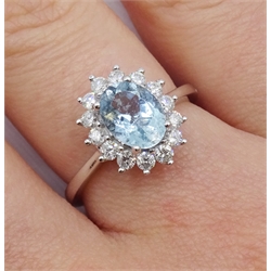 18ct white gold oval aquamarine and diamond cluster ring, hallmarked