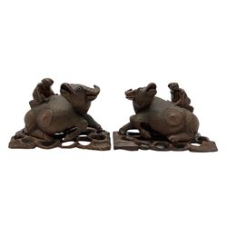 Pair of late 19th century Chinese carved recumbent water buffalo each with a boy on its back and on pierced stands L27cm 