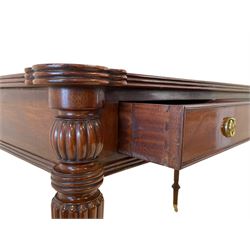 Regency style mahogany writing table, the top with projecting shaped corners and moulded edge with leather inset, fitted with three frieze drawers mirrored by three false drawers, raised on turned and reeded tapering supports, terminating at brass cups and castors, W126cm, H83cm, D66cm