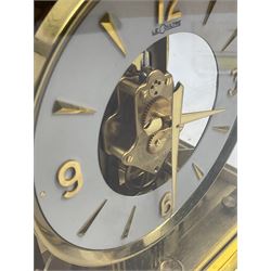 A 1970’s circa gilt brass cased Jager- LeCoultre Atmos Clock, 15 jewelled unadjusted Swiss movement inscribed LeCoultre Atmos with serial number 164558, with five glazed panels, five-inch chapter ring with applied Arabic numerals and markers with baton hands, skeletonised movement with oscillating balance wheel beneath, spirit level and two leveling feet to the base, with original LeCoultre packaging, mahogany wall bracket and original paperwork, booklets, etc.
*Created by the Jaeger LeCoultre watchmakers in 1928 the Atmos clock receives its power from minute changes in atmospheric temperature, hence the clocks name.  Within a sealed capsule, a mixture of gases expand and contract with each temperature change. At a temperature between 15° and 30° Celsius, a variation of a single degree is enough to power the clock for two days. In order to operate, the clock functions with an almost complete lack of friction. W21.5cm, H23.5cm, D17cm