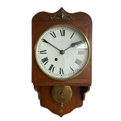 An early 20th century wall clock in a mahogany case, ogee shaped pediment, movement bracket and conforming apron, fusee timepiece movement, 8” painted metal dial with Roman numerals, minute track and steel spade hands, with a cast brass bezel and flat glass. Pendulum with a drilled central locking keep.
