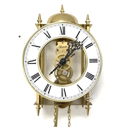 Hermle brass skeleton weight driven wall clock, eight day movement with passing strike to exterior bell, white enamel dial with Roman chapter ring