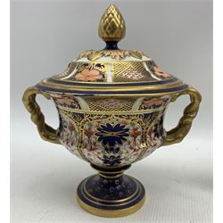 Early 20th century Royal Crown Derby Old Imari twin handled vase and cover, with acorn finial and circular foot, c1904, no. 1128, H21cm, together with other Royal Crown Derby including an Old imari plate D21cm, globular vase, small campana urn and vase & cover, together with a Traditional Imari sugar bowl no. 2451 (6)