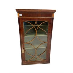 George III mahogany corner wall cabinet, the glazed door of tracery design enclosing three fixed shelves 