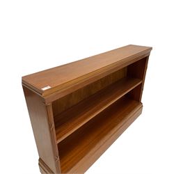 20th century mahogany book case, the rectangular and projecting top over one shelf, raised on a plinth base 